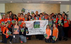 Donor Alliance Colorado Denver Wyoming Our Culture Broncos Group with sign