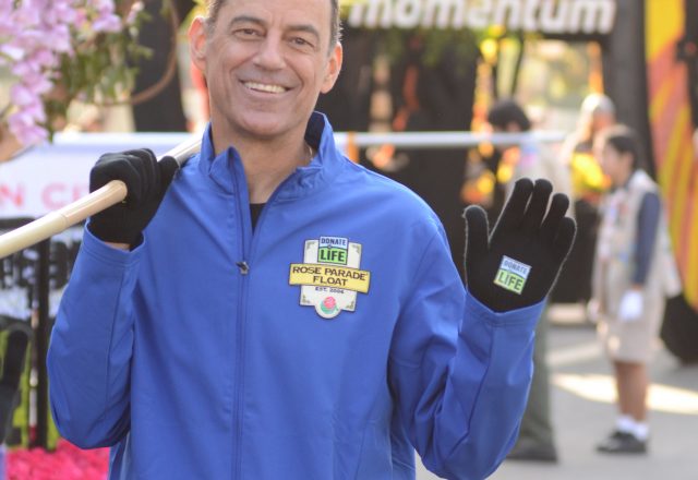 Colorado kidney transplant recipient Jeff Leone walks alongside the Donate Life Rose Parade Float
