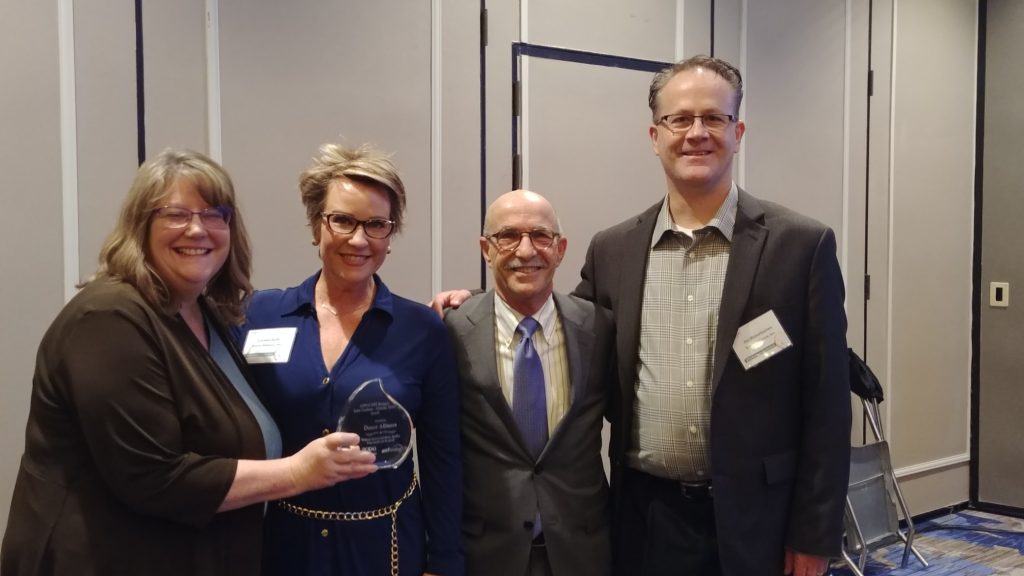 Donor Alliance representatives pose with AOPO award